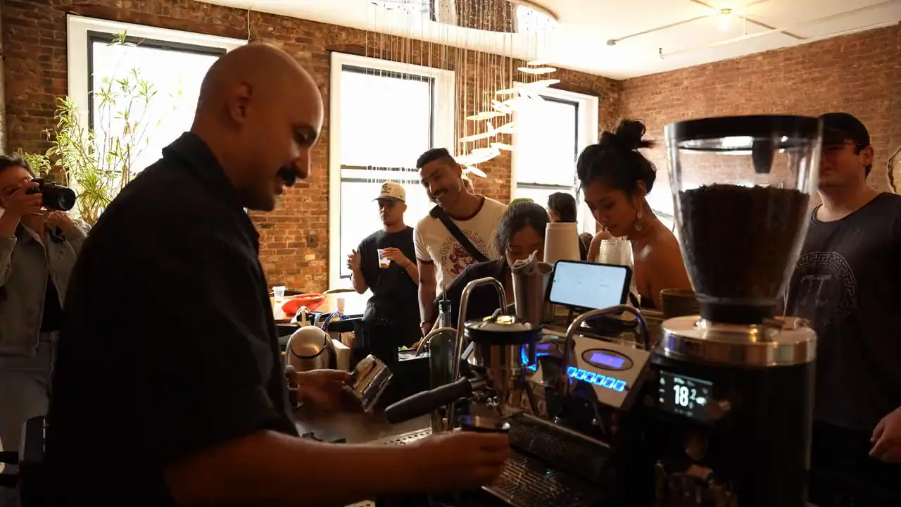 Michael Valdez pulls shots on the ValdezNY espresso cart as guests crowd the bar