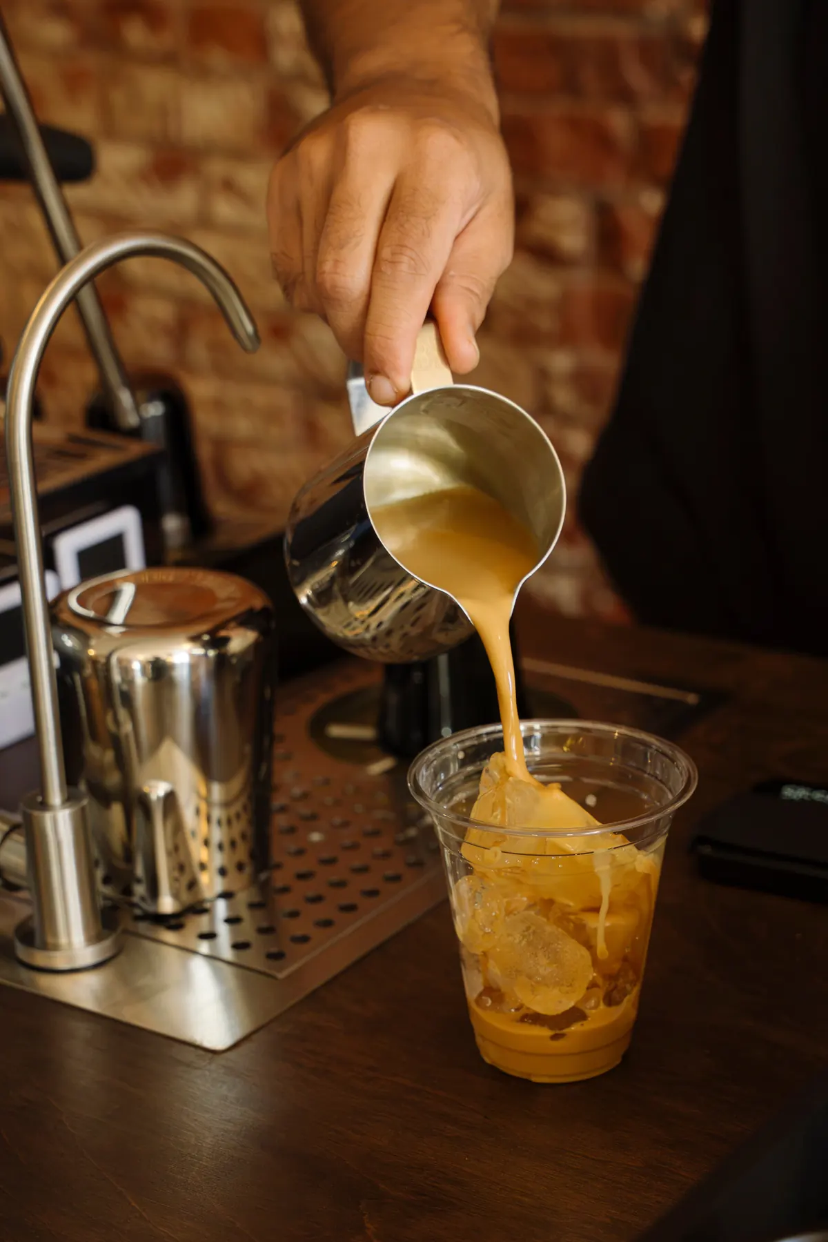 An iced latte poured over ice at the ValdezNY espresso bar