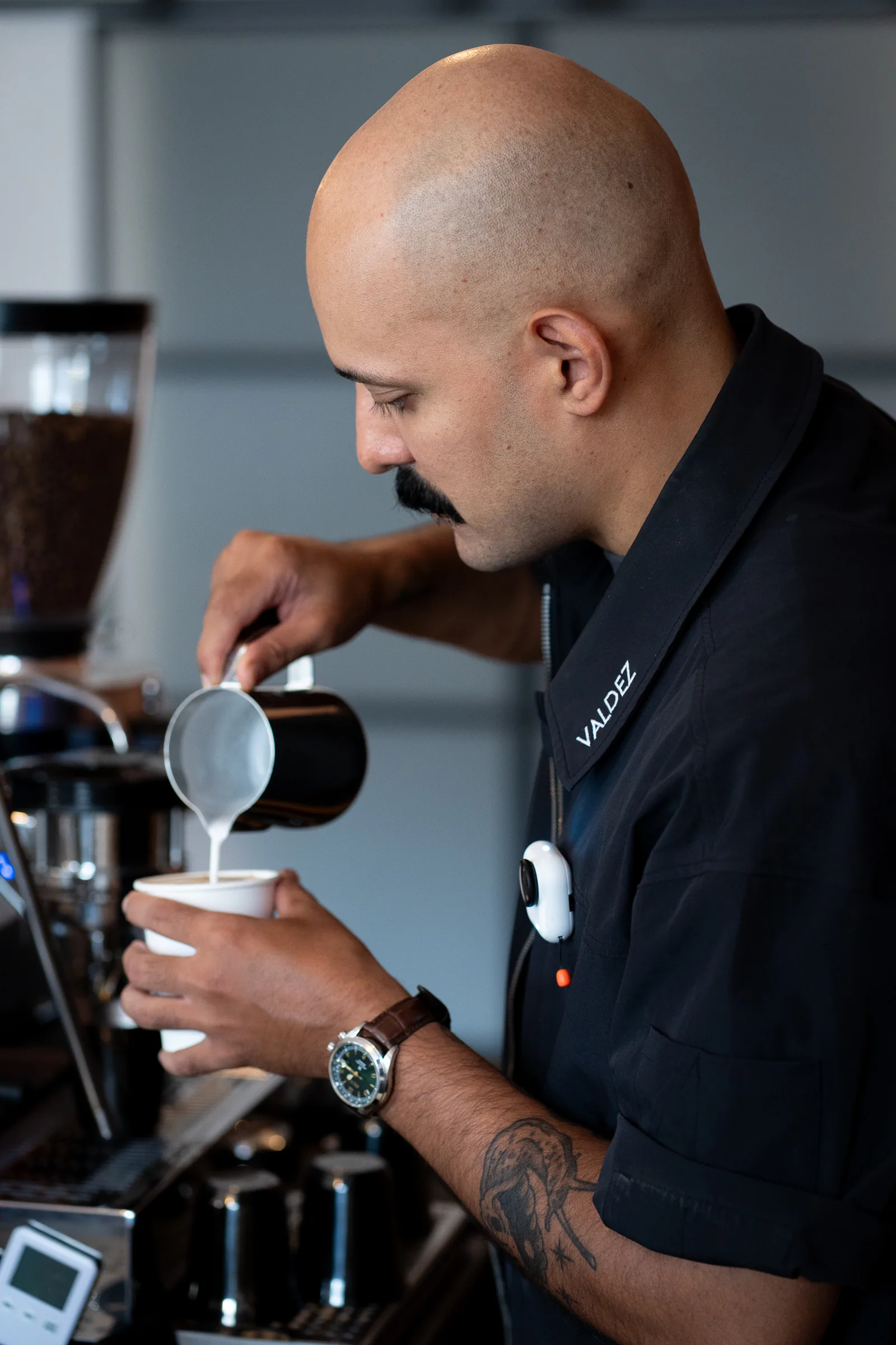 Michael Valdez, founder of ValdezNY, pours latte art at the espresso bar